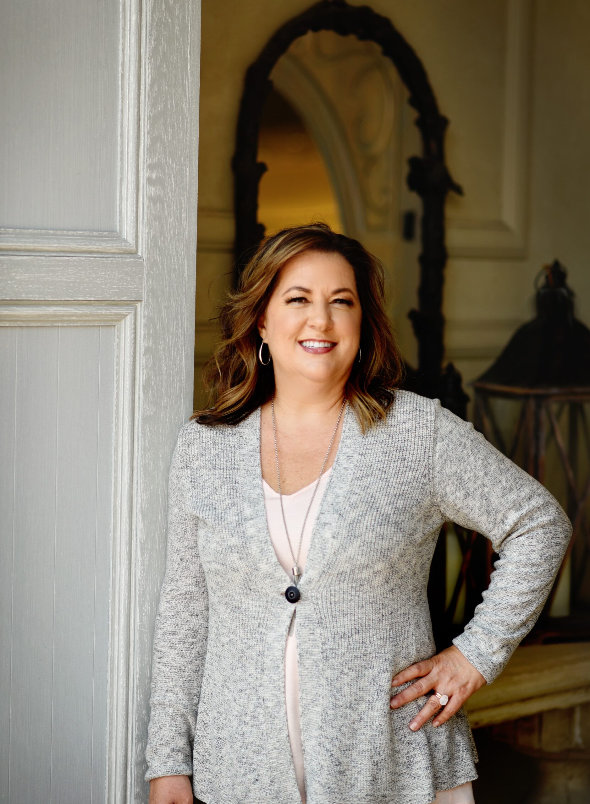 JEN RIGLEY standing in doorway